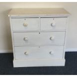 A painted pine chest of four drawers. Est. £30 - £