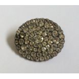 A Georgian oval brooch with large central stone. A