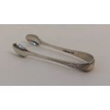 An attractive pair of bright cut silver sugar tong