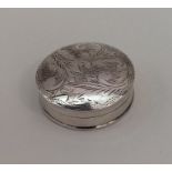 A circular silver hinged top pill box with floral