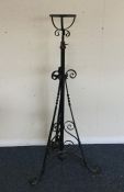 A cast iron lamp stand with scroll decoration. Est