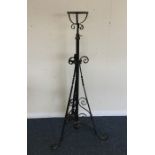 A cast iron lamp stand with scroll decoration. Est