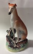 A tall Staffordshire figure of a greyhound with de