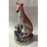 A tall Staffordshire figure of a greyhound with de