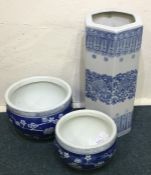 Two large blue and white planters together with a