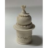 An unusual carved ivory box in the form of a templ