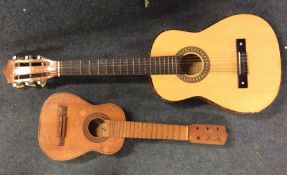 A child's size guitar together with one other. Est