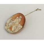 An oval gold framed cameo depicting figures. Appro