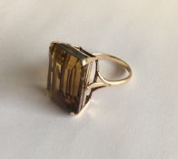 A large yellow stone ring in 9 carat mount. Approx