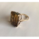 A large yellow stone ring in 9 carat mount. Approx