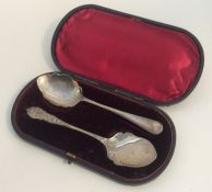 Two silver preserve spoons contained within a box.