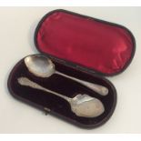 Two silver preserve spoons contained within a box.