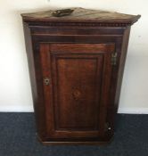 A Georgian oak corner cupboard with shell motif. E