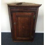 A Georgian oak corner cupboard with shell motif. E