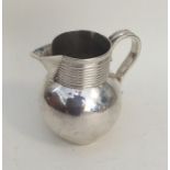 A small Georgian silver baluster shaped cream jug