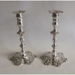 A good pair of cast silver taper candlesticks with