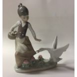 A Lladro figure of a child with goose. Est. £20 -