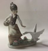 A Lladro figure of a child with goose. Est. £20 -