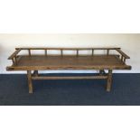 A hardwood bench on tapering supports. Est. £20 -