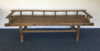 A hardwood bench on tapering supports. Est. £20 -