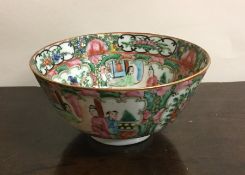 A Canton tea bowl decorated in bright colours. App