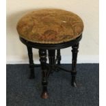 An ebony and tapestry stool. Est. £20 - £30.