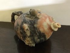 A small soapstone bullet shaped teapot of Chinese