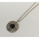 A stylish circular silver pendant with loop top. A