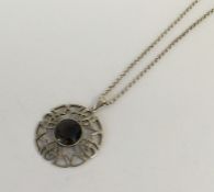 A stylish circular silver pendant with loop top. A