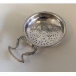 A Georgian scroll decorated silver lemon strainer