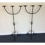 A pair of wrought iron candle holders. Est. £20 -