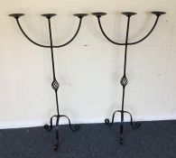 A pair of wrought iron candle holders. Est. £20 -