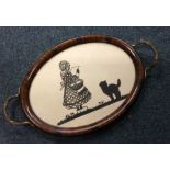 An attractive oval tray decorated with a silhouett
