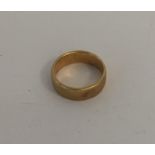 An 18 carat gold wedding band. Approx. 4.4 grams.