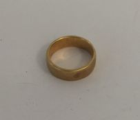 An 18 carat gold wedding band. Approx. 4.4 grams.