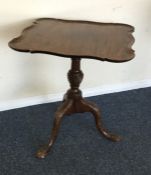 A square Edwardian occasional table with carved de