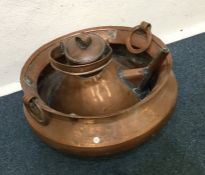 A copper two handled bowl together with a kettle.