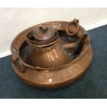 A copper two handled bowl together with a kettle.