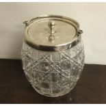 A cut glass and silver mounted biscuit barrel. She