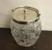 A cut glass and silver mounted biscuit barrel. She