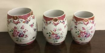 A good set of three tapering Famille Rose tankards