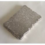 A large silver hinged top card case with floral de