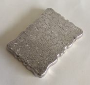 A large silver hinged top card case with floral de