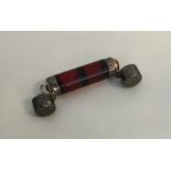 A cranberry glass double ended scent bottle with s