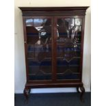 A Georgian mahogany two door glazed cabinet on cab