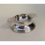 An Edwardian silver tea strainer with pierced hand