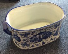 An unusual large blue and white planter decorated