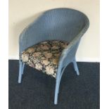 A blue Lloyd Loom chair. Est. £10 - £20.
