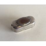 An oval silver snuff box with central agate. Punch