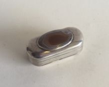 An oval silver snuff box with central agate. Punch